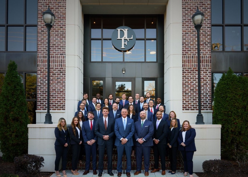 Derrick Law Firm team in front of the office building