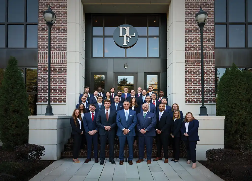 Derrick Law Firm team in front of the office building